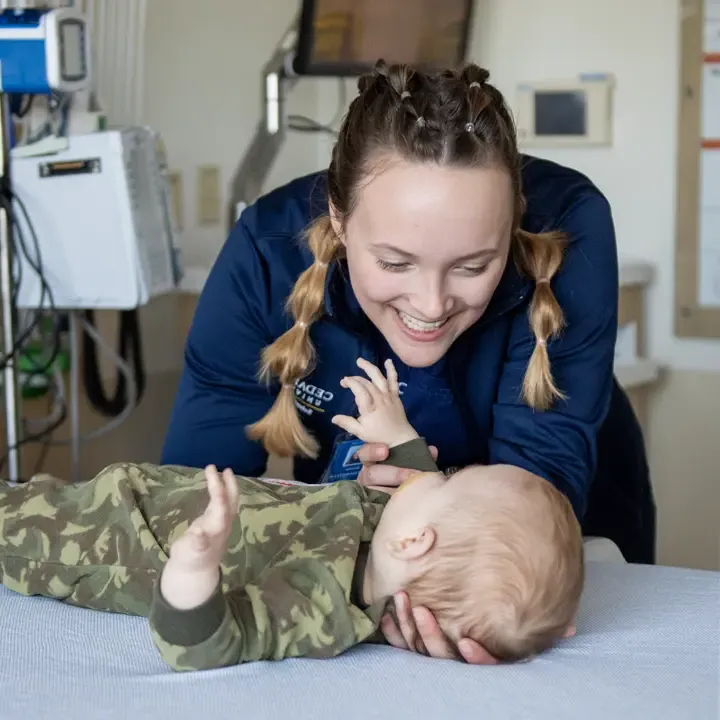 Nursing student caring for an infant.